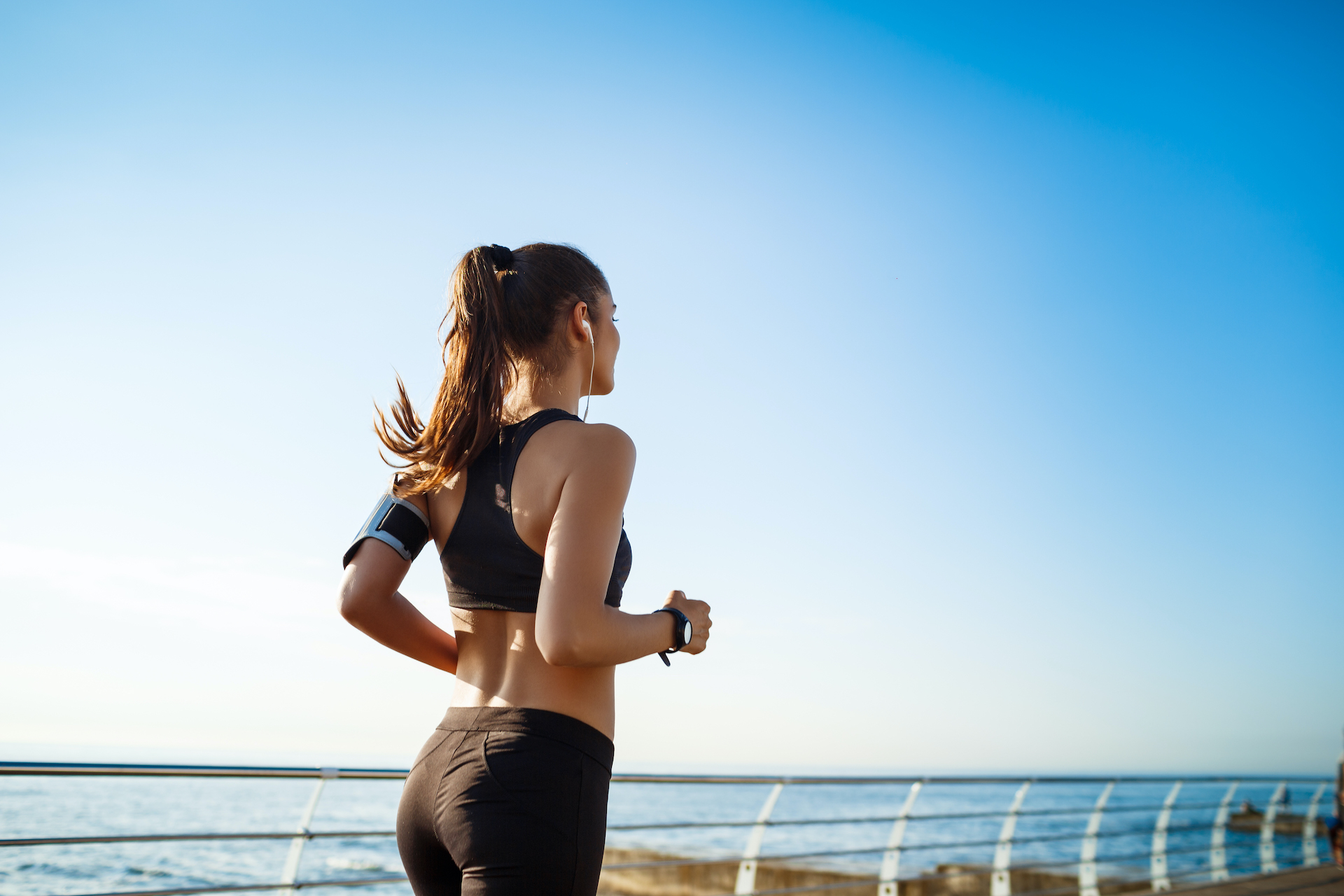 picture young attractive fitness woman jogging with sea wall
